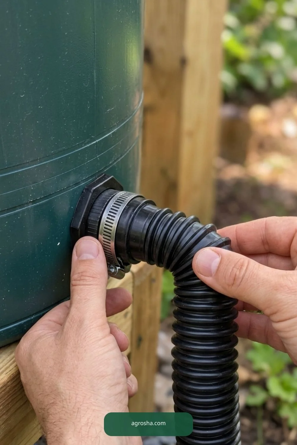 Hands attaching flexible black corrugated overflow hose to rain barrel outlet