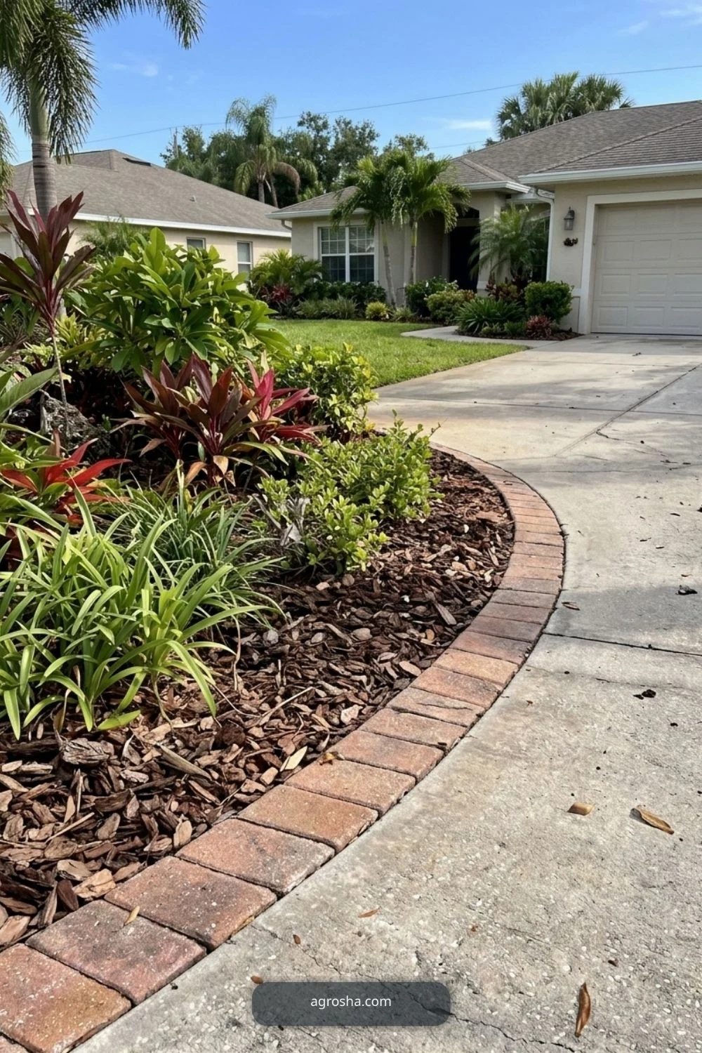 Florida driveway border showing brick or stone edge around a curved bed