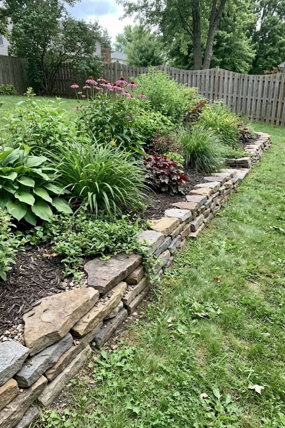 Tiered Stone Border defining a flower bed in a suburban backyard
