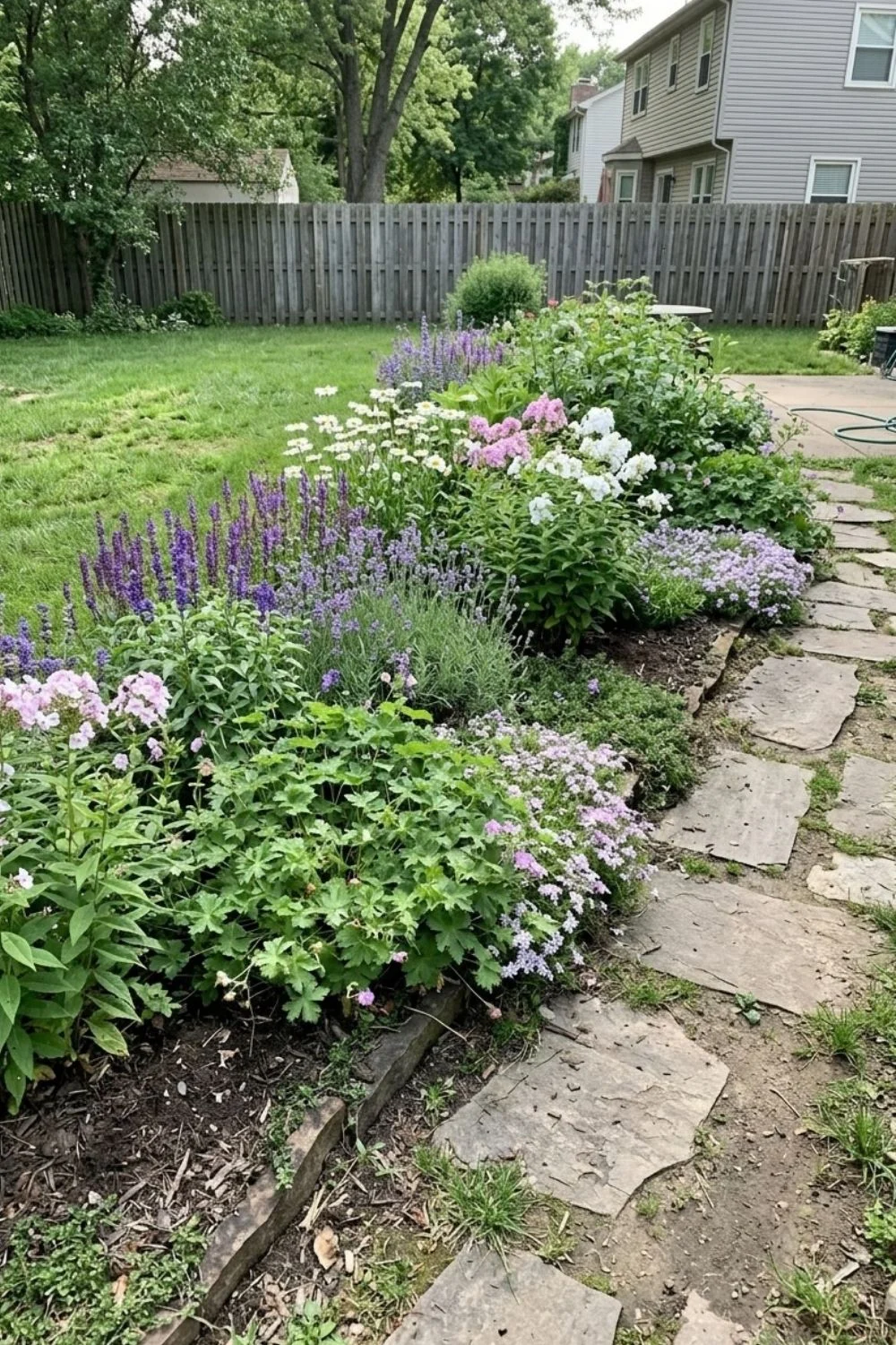 Cottage-Style Soft Plant Edge defining a flower bed in a suburban backyard