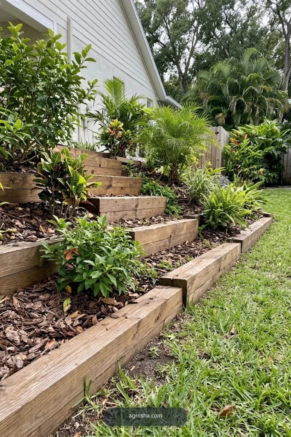 Florida landscape edging example showing timber step edge on a sloped bed